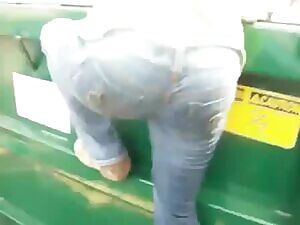 Wetting her jeans while climbing on a dumpster