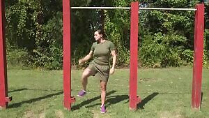 Military girl doing pull-ups.