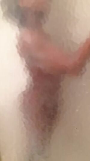 Pressed against the shower wall