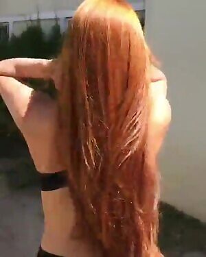Redhead plays with her beautiful hair