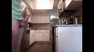 Walking around aimlessly and stretching in my kitchen with my hard cock out.