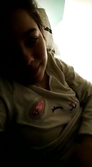 Showing her boobs in bed