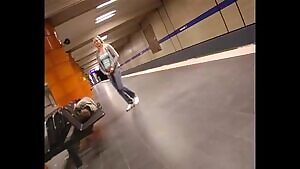 Girl pees next to a sleeping guy in a train station