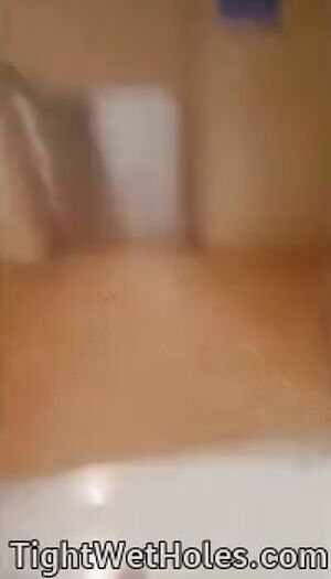 Spreading her legs in a public bathroom