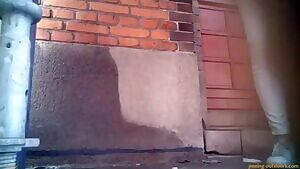 Girl pulls down her white pants and pees forcefully in the street