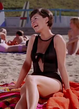 Yvonne Craig giggling and jiggling on the beach as Batgirl