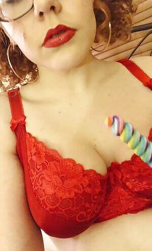 Curly pigtails having fun with lollipop