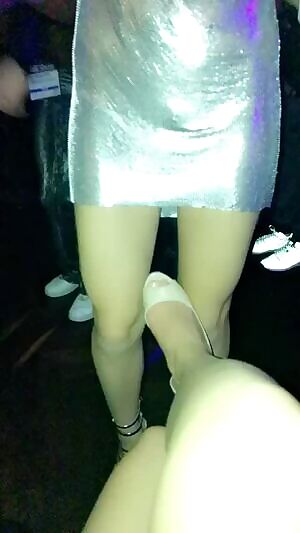 A girl lifting up her friends skirt to show her pussy on the dance floor