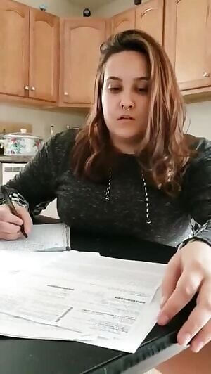 Nonchalant pissing while she does her paperwork