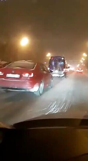 Two half-naked girls dance and entertain drivers