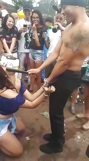 Bitch sucking on a stick like it's a dick in front of a crowd at a festival