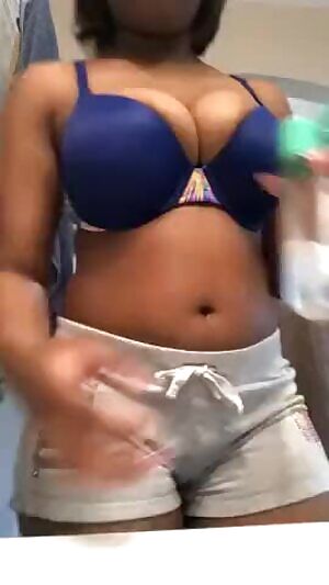 Rubbing oil on her amazing tits