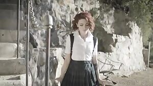 Pale petite girl with plaid skirt and backpack flashing her buttplug