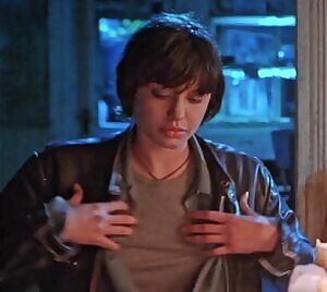 A 21 year old Angelina Jolie revealing her perfect breasts