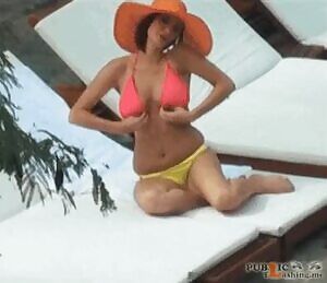 in a pink bikini and orange hat